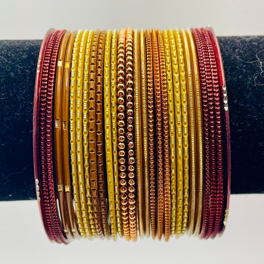 Red, tan, and gold bangles set. 7 1/2 inches. 28 bracelets